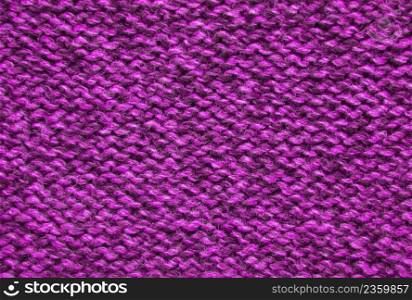The texture of a knitted woolen fabric pink.