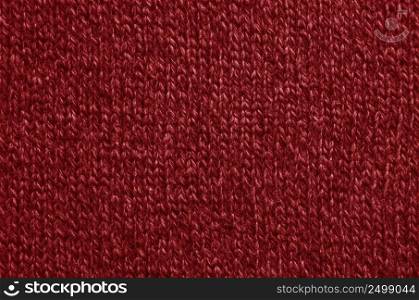 The texture of a knitted woolen fabric red.