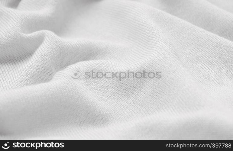 The texture of a knitted woolen fabric white.