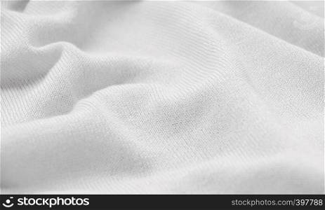 The texture of a knitted woolen fabric white.
