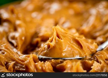 The texture of peanut butter. Macro background. High quality photo. The texture of peanut butter.