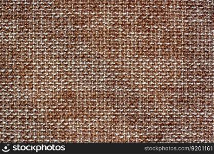 The texture of the fabric. Brown woolen interlaced fabric. Copy space