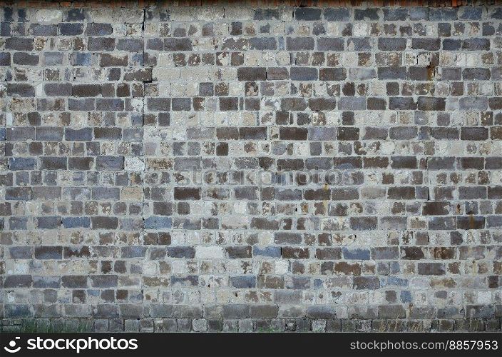 The texture of the warehouse wall from a variety of rough stones of different shades