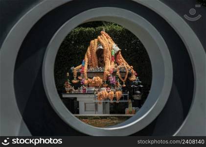 The Thao Maha Phrom Shrineis a shrine which houses a statue of Phra Phrom  Four faced god  Looking Through space in geometric figure of circle architecture. Selective focus.