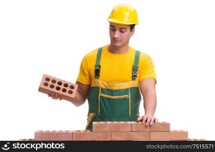 The the handsome construction worker building brick wall. The handsome construction worker building brick wall