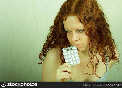 The thoughtful girl holds in a hand of a tablet and reflects on the developed situation