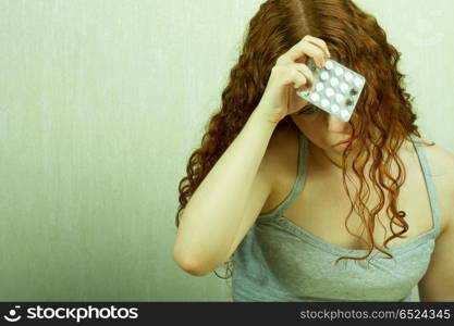 The thoughtful girl holds in a hand of a tablet and reflects on the developed situation. Condition of a hopelessness