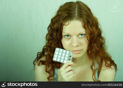 The thoughtful girl holds in a hand of a tablet and reflects on the developed situation. Condition of a hopelessness