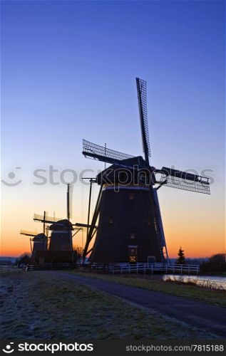 The three monumental windmills at Leidschendam, the Netherlands, neatly aligned on a beautiful winter dawn