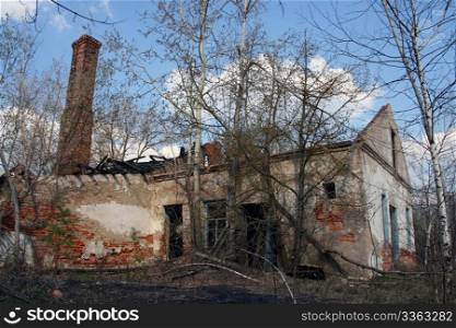 The thrown house in the Chernobyl zone with the destroyed walls and the fallen off roof