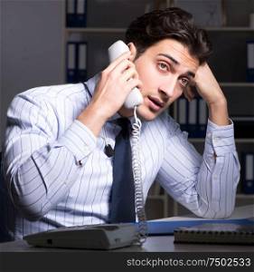 The tired and exhausted helpdesk operator during night shift. Tired and exhausted helpdesk operator during night shift