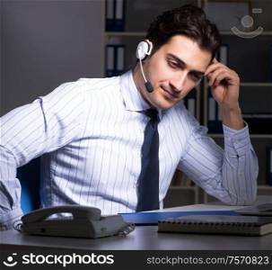 The tired and exhausted helpdesk operator during night shift. Tired and exhausted helpdesk operator during night shift