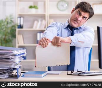 The tired businessman with too much paperwork. Tired businessman with too much paperwork