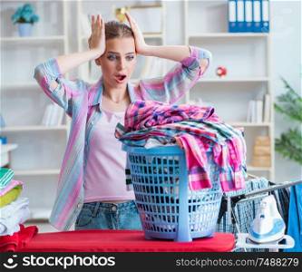 The tired depressed housewife doing laundry. Tired depressed housewife doing laundry