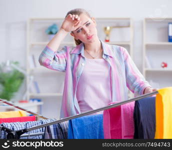 The tired depressed housewife doing laundry. Tired depressed housewife doing laundry