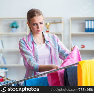 The tired depressed housewife doing laundry. Tired depressed housewife doing laundry