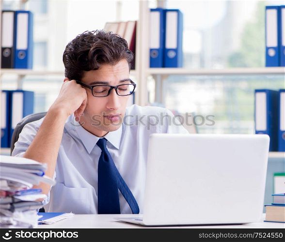 The tired exhausted businessman sitting in the office. Tired exhausted businessman sitting in the office