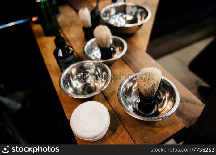 the tools of a Barber on the desktop in front of the mirror