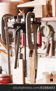 The tools of carpenter or locksmith hang on the shelf. Set of locksmith tools