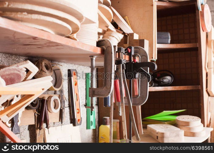 The tools of carpenter or locksmith hang on the shelf. Set of locksmith tools