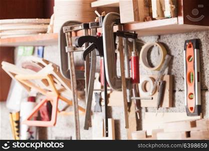 The tools of carpenter or locksmith hang on the shelf. Set of locksmith tools