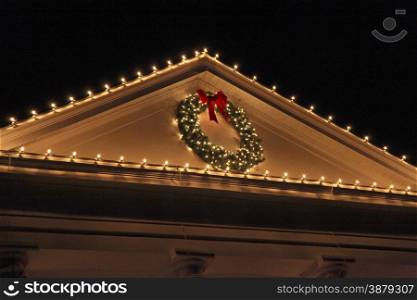 The top of a house with Christmas Lights