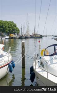 The tourist harbor of Enkhuizen, the Netherlands, with a few yachts and some fishing boats in the far end