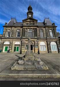 The Town Hall building in Buxton, a spa town in the Borough of High Peak in Derbyshire, England. It is the highest market town in England, at 1,000 feet (300m) above sea level. Buxton Town Hall was opened in 1889 in the Market Place in the towns central Conservation Area.