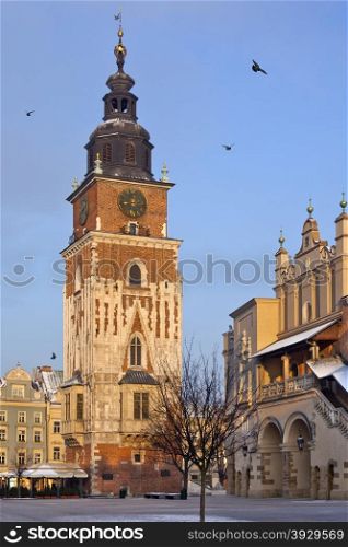 The Town Hall Clock Tower and the southern end of the Cloth Hall Building in the Market Square (Rynek Glowny) in the city of Krakow in Poland.