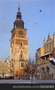 The Town Hall Clock Tower and the southern end of the Cloth Hall Building in the Market Square (Rynek Glowny) in the city of Krakow in Poland.