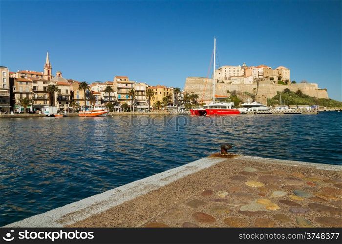 The town, port and citadel of Calvi in Corsica with yachts in the harbour