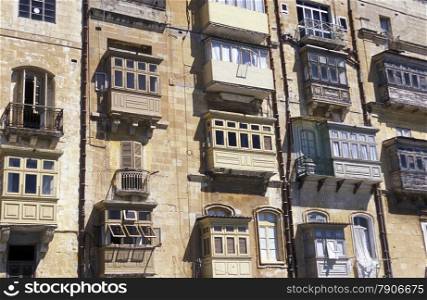 The traditional Balconys on the Houses in the Old Town of the city of Valletta on the Island of Malta in the Mediterranean Sea in Europe.&#xA;