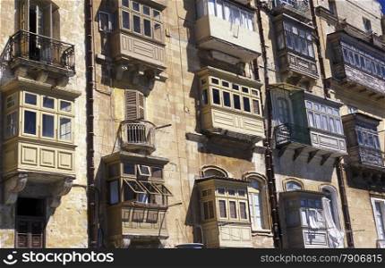 The traditional Balconys on the Houses in the Old Town of the city of Valletta on the Island of Malta in the Mediterranean Sea in Europe.&#xA;