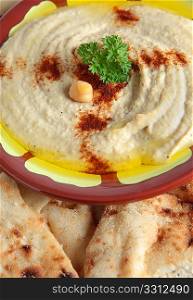 The traditional Middle Eastern chickpea dip, hummus with tahini, served with Egyptian flat bread.