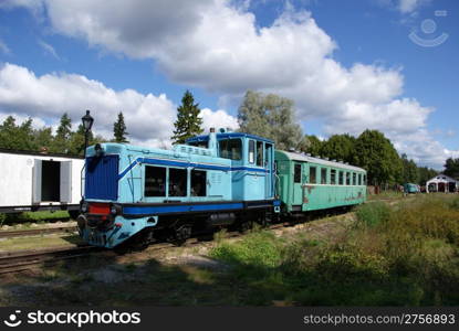 The train station is on a background of clouds and blue sky