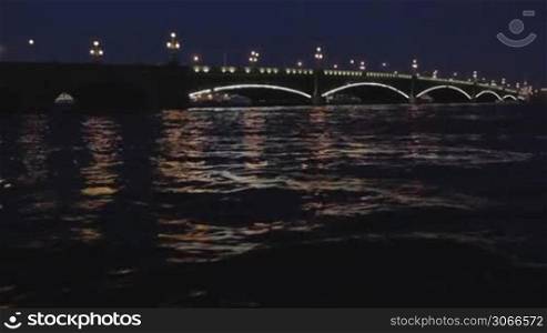The Troitskiy Bridge in Saint Petersburg at night. Sail across the Neva river.