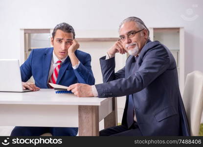 The two businessman discussing business in office. Two businessman discussing business in office