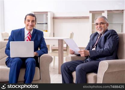 The two businessman discussing business in office. Two businessman discussing business in office