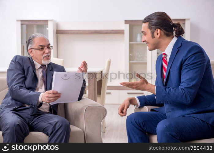 The two businessman discussing business in office. Two businessman discussing business in office