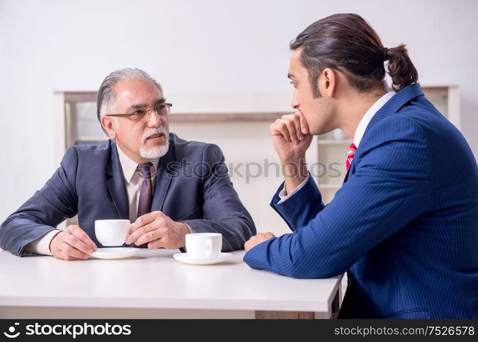 The two businessman discussing business in office. Two businessman discussing business in office