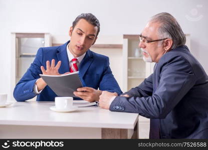 The two businessman discussing business in office. Two businessman discussing business in office