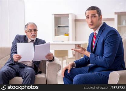 The two businessman discussing business in office. Two businessman discussing business in office