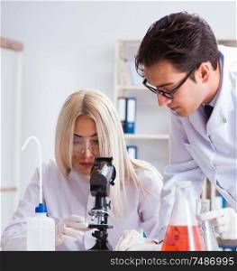 The two chemists having discussion in lab. Two chemists having discussion in lab