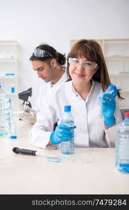 The two chemists working in the lab. Two chemists working in the lab