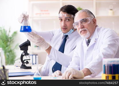 The two chemists working in the lab. Two chemists working in the lab