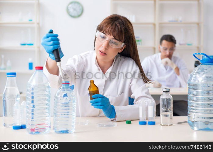 The two chemists working in the lab. Two chemists working in the lab