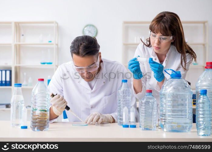 The two chemists working in the lab. Two chemists working in the lab