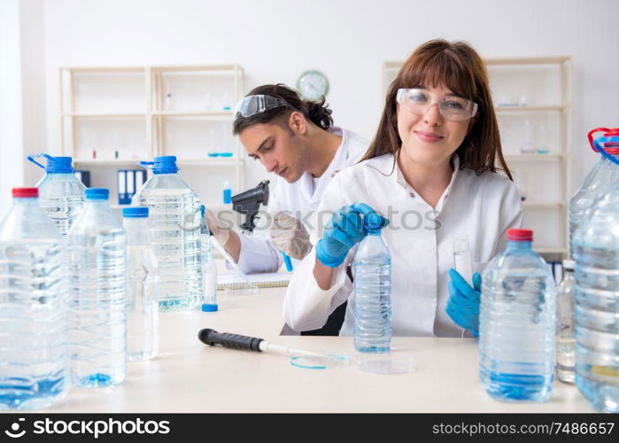 The two chemists working in the lab. Two chemists working in the lab