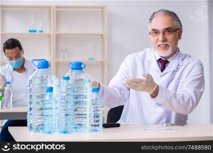 The two chemists working in the lab . Two chemists working in the lab