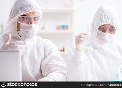 The two chemists working in the lab. Two chemists working in the lab